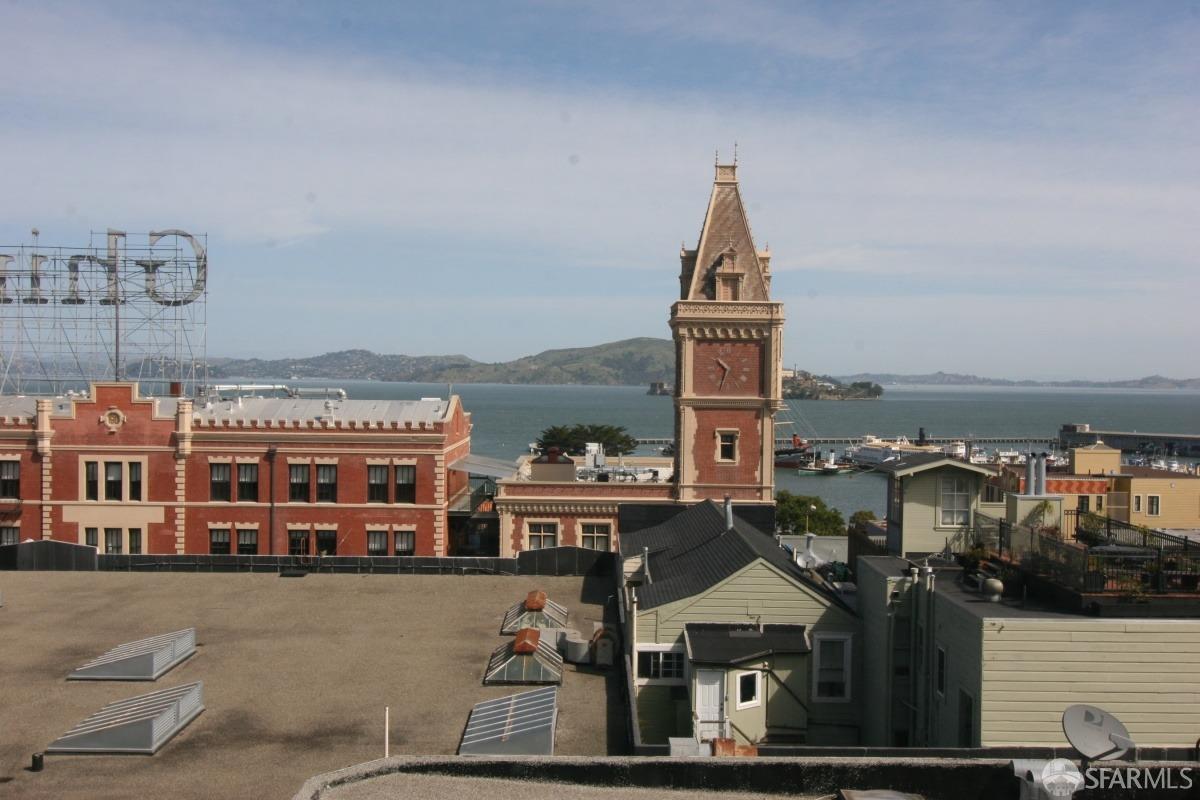 a view of a large building with a clock tower in the middle