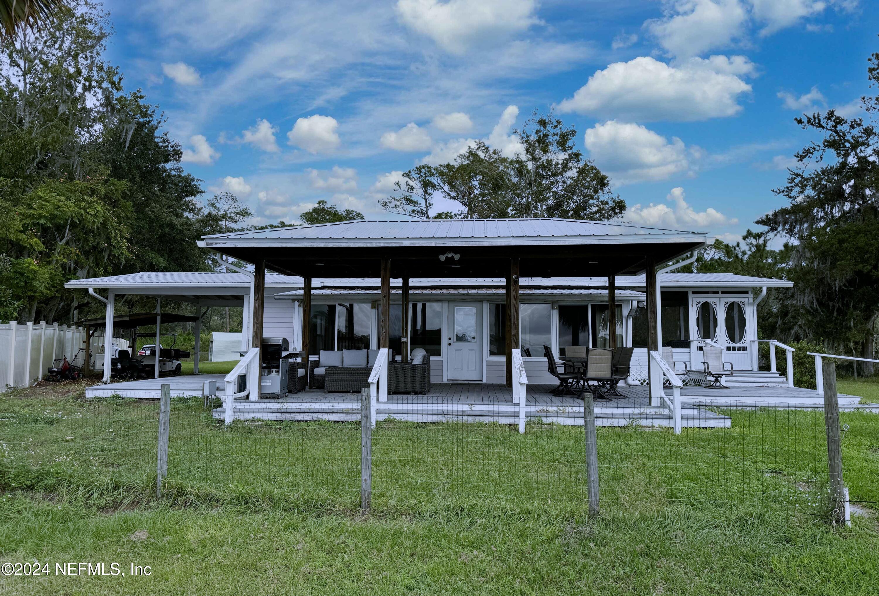 a front view of a house with a garden and seating