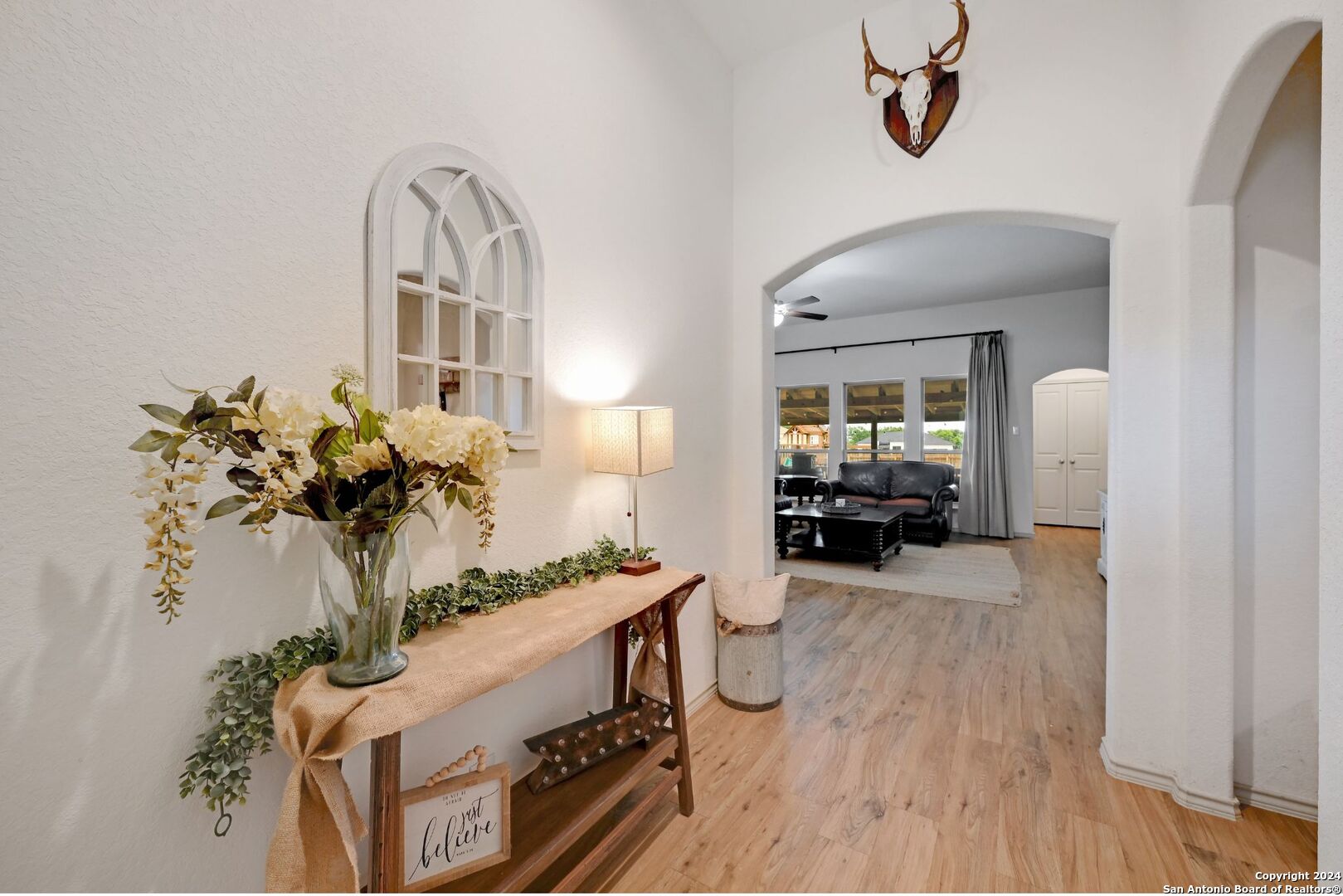 a view of living room filled with furniture and a chandelier