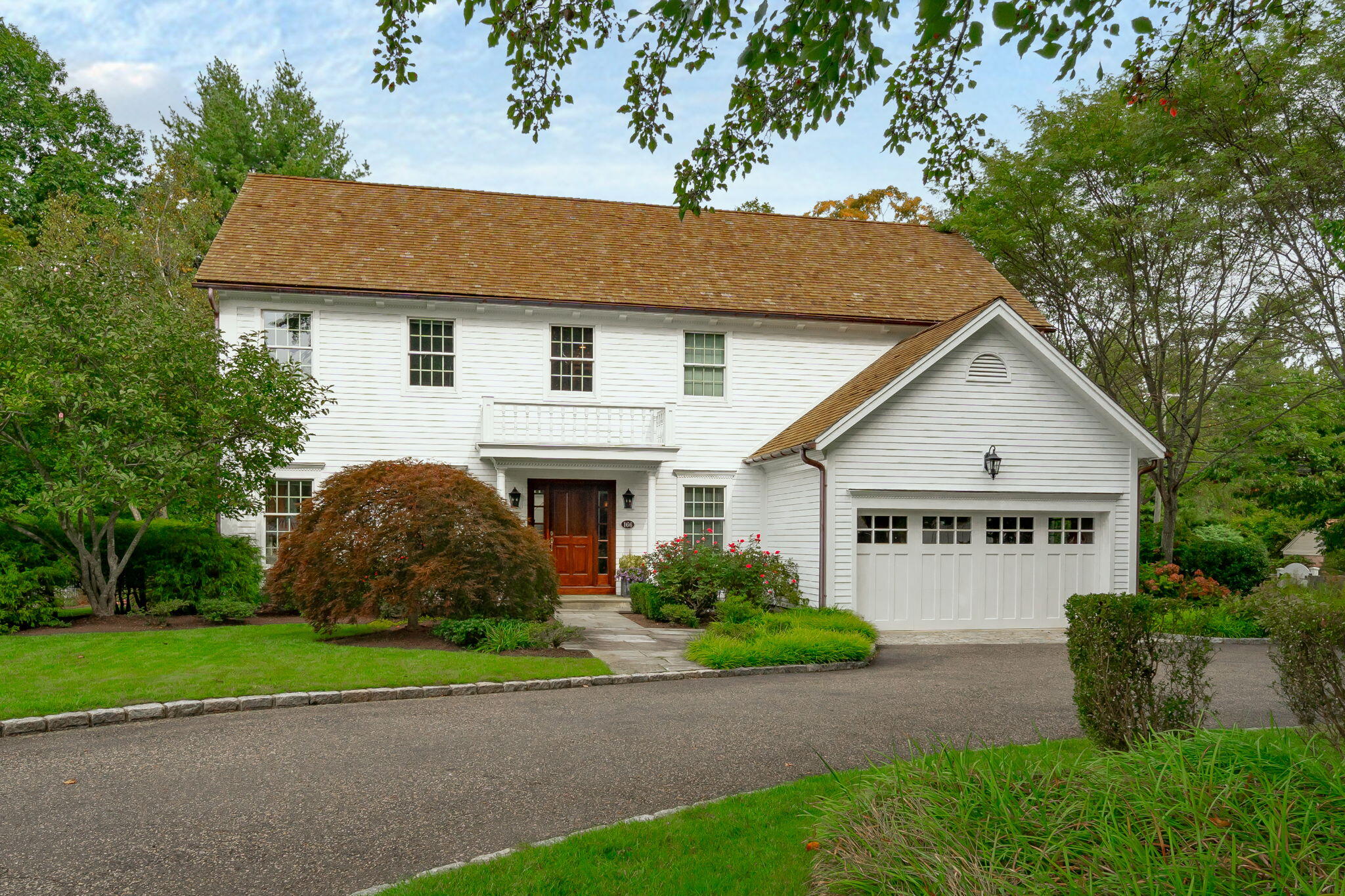 a house that has a tree in front of it