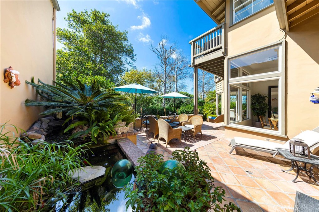 a view of a house with backyard sitting area and garden