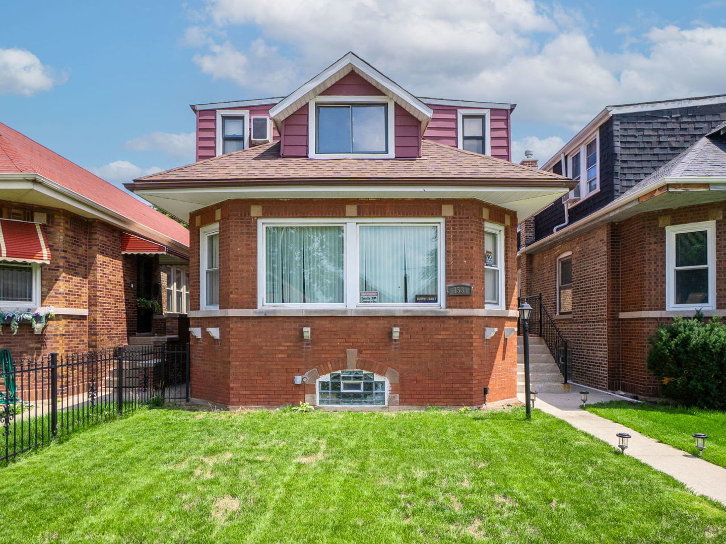 a front view of a house with a yard