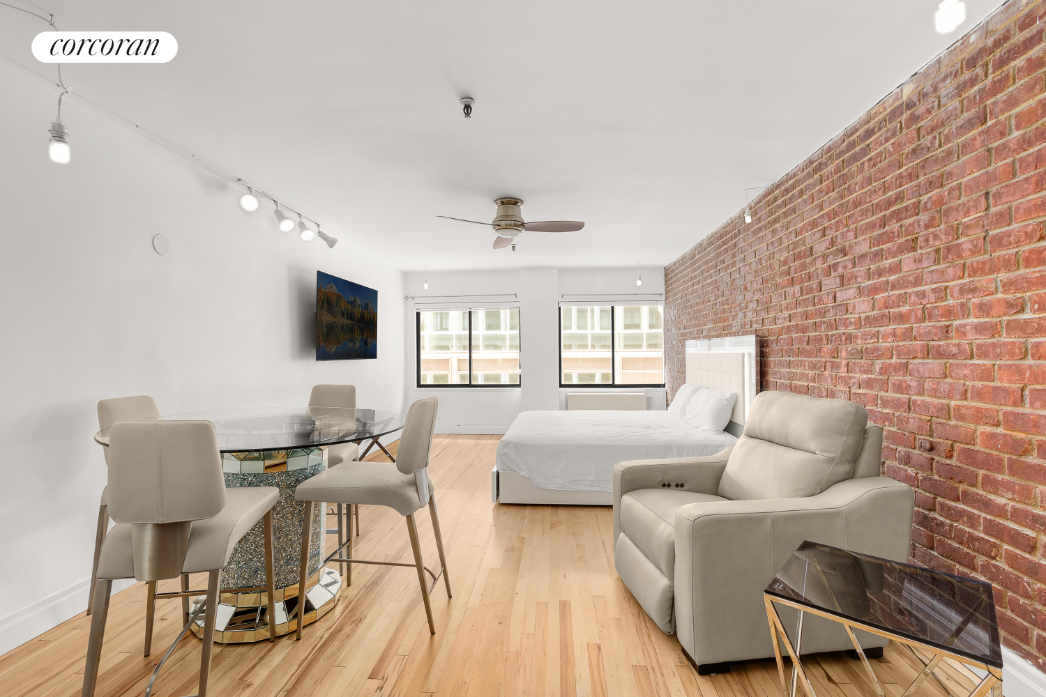 a living room with furniture a flat screen tv and a large window