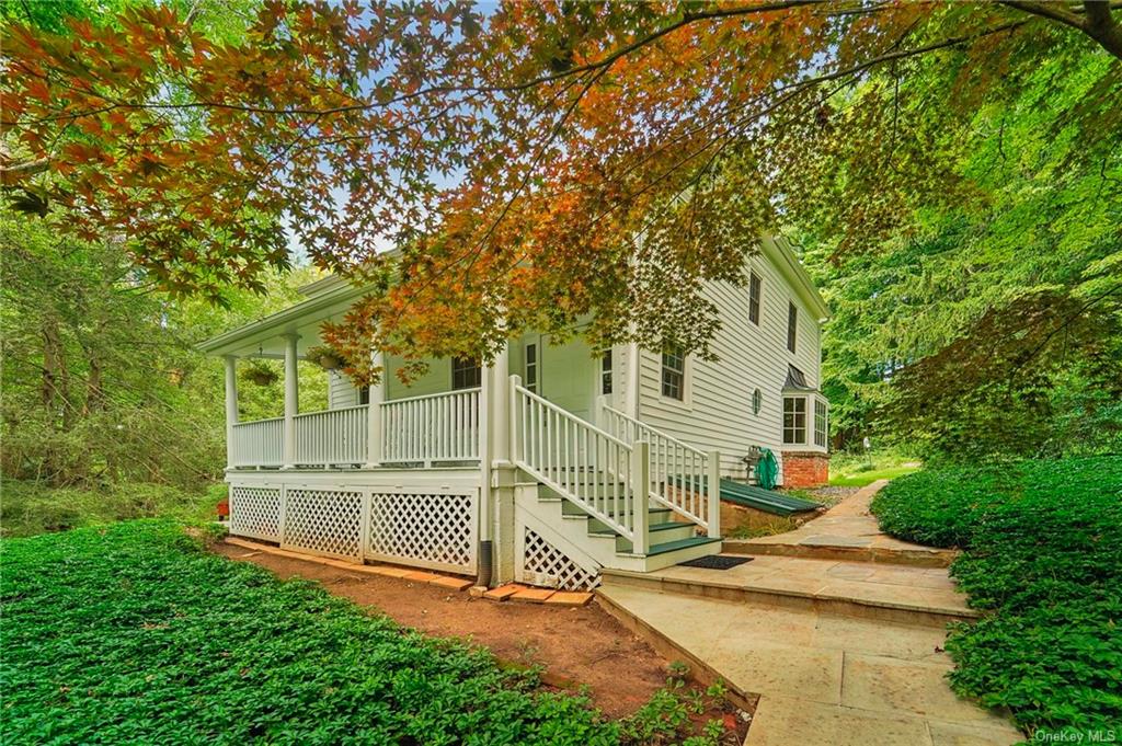 a view of a house with a yard and sitting area