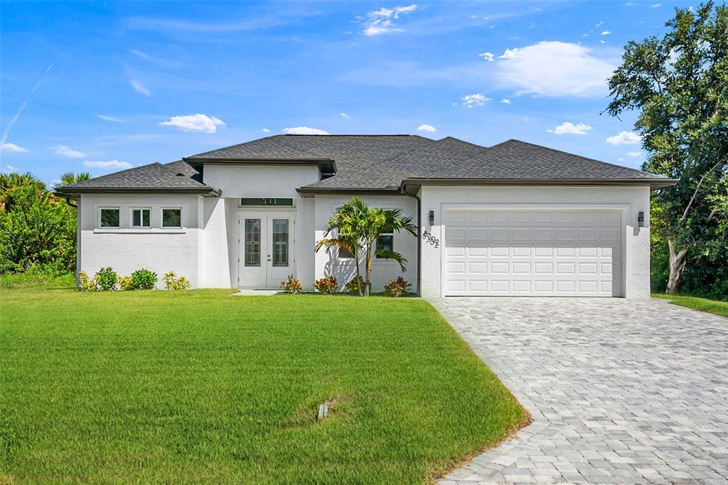 a front view of a house with a garden and yard