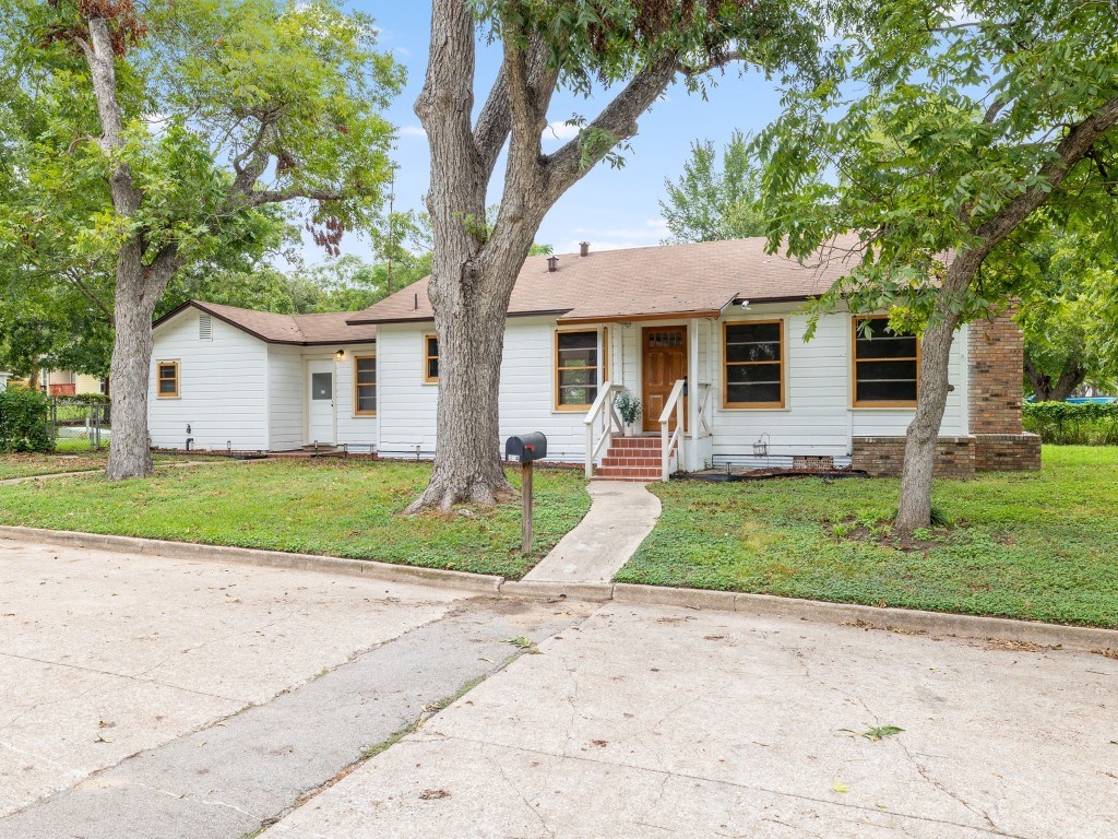 a front view of house with yard and green space