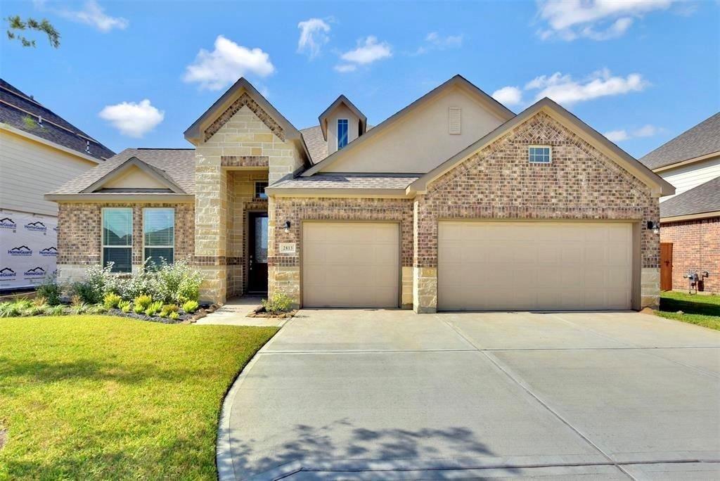 a front view of a house with a yard and garage