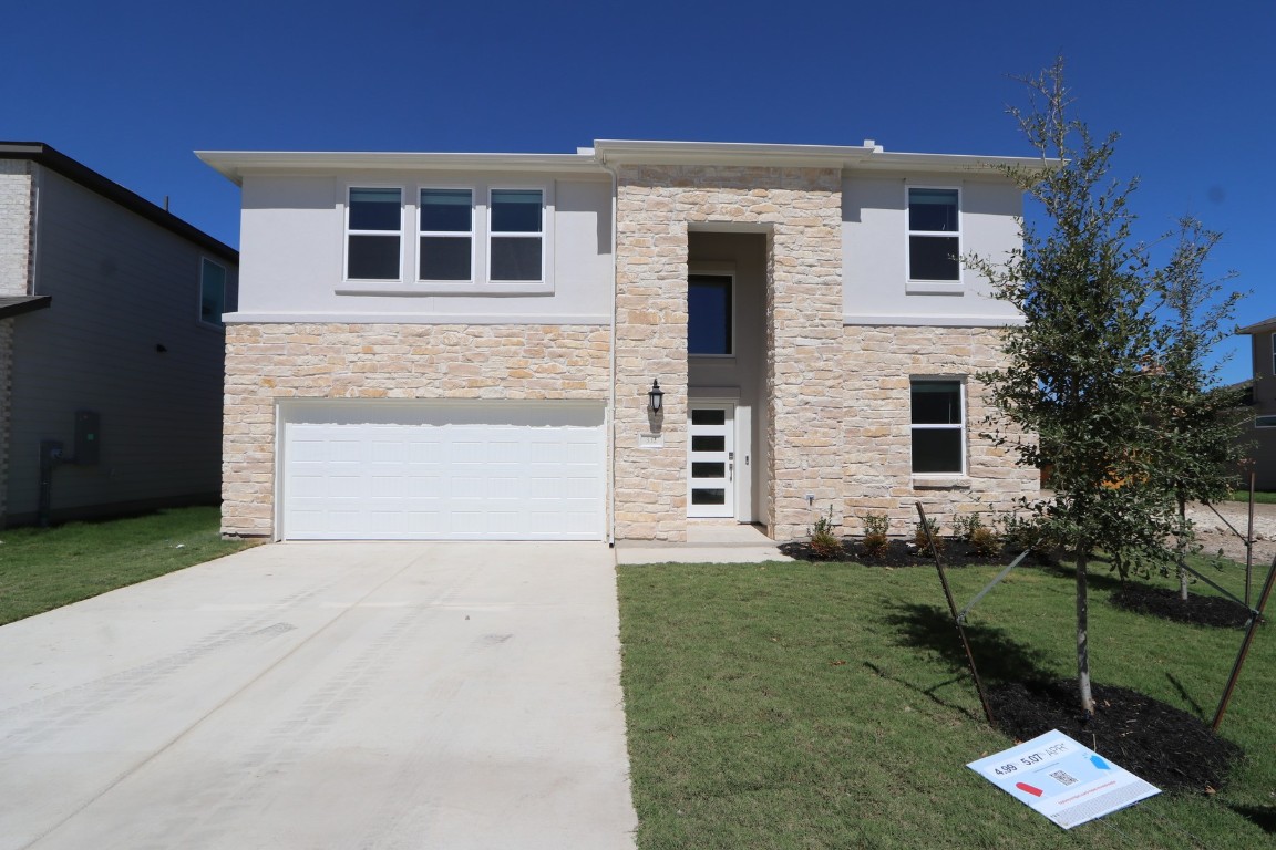 a front view of a house with a yard