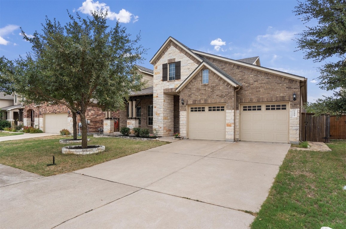 a front view of a house with a yard and garage