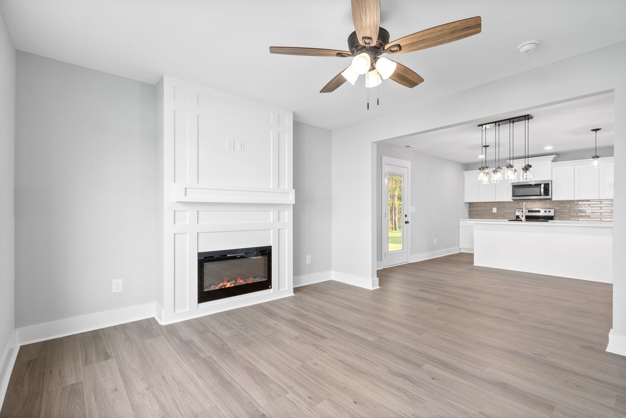 a view of a kitchen with an empty space and a fireplace