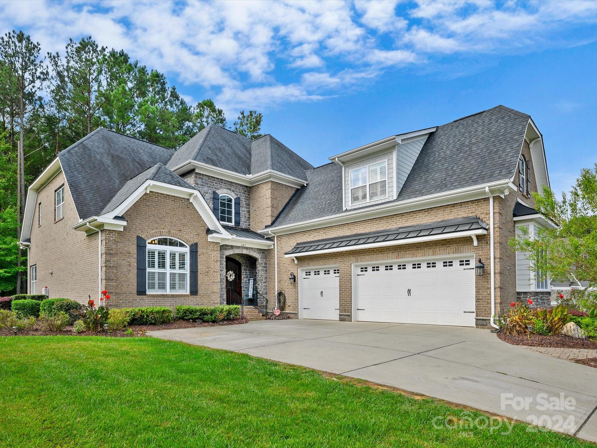 a front view of a house with a yard and garage