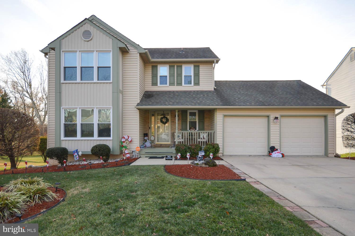 a front view of a house with a yard and outdoor seating