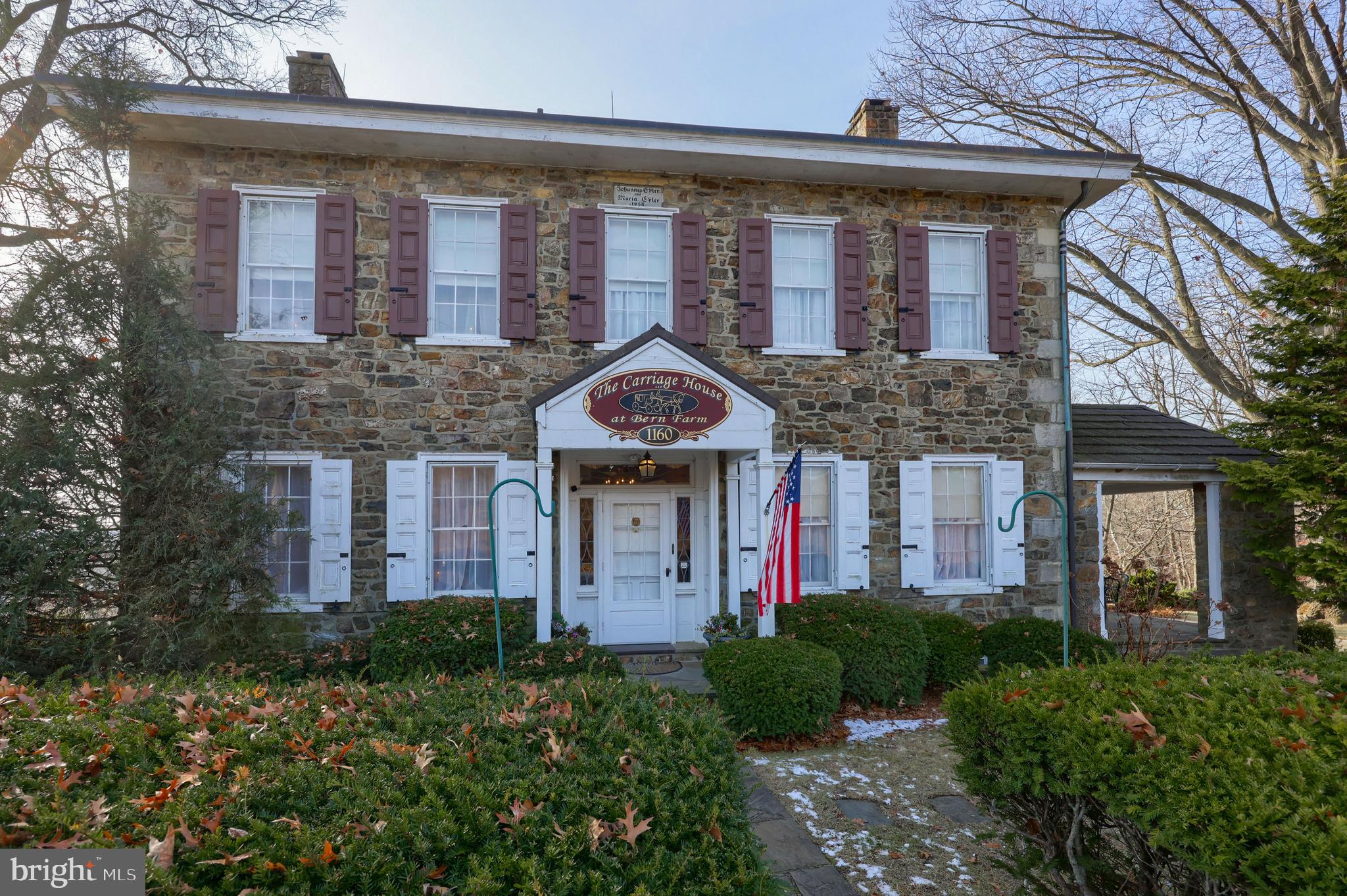 front view of a brick house with a small yard