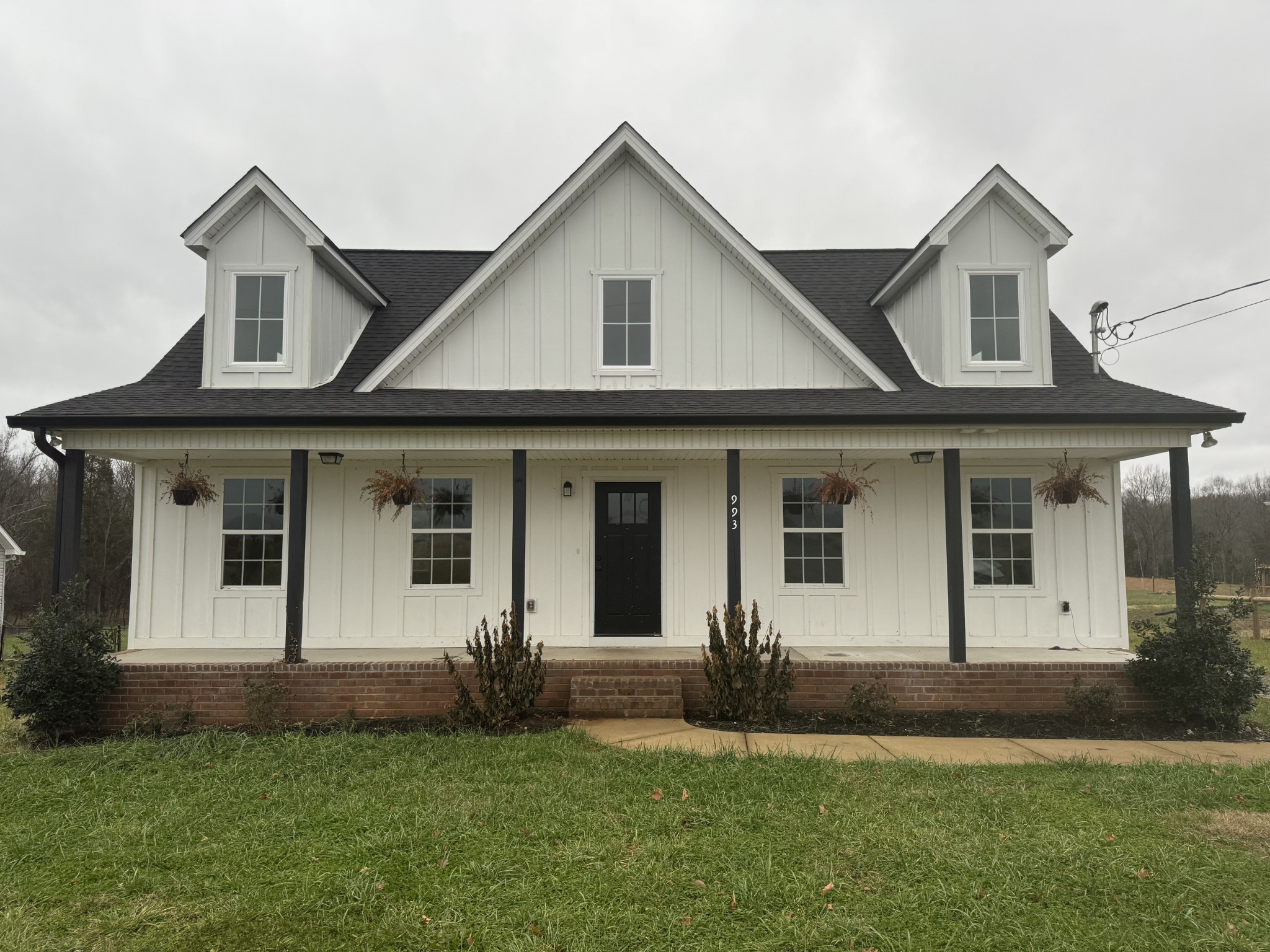 a front view of a house with a garden