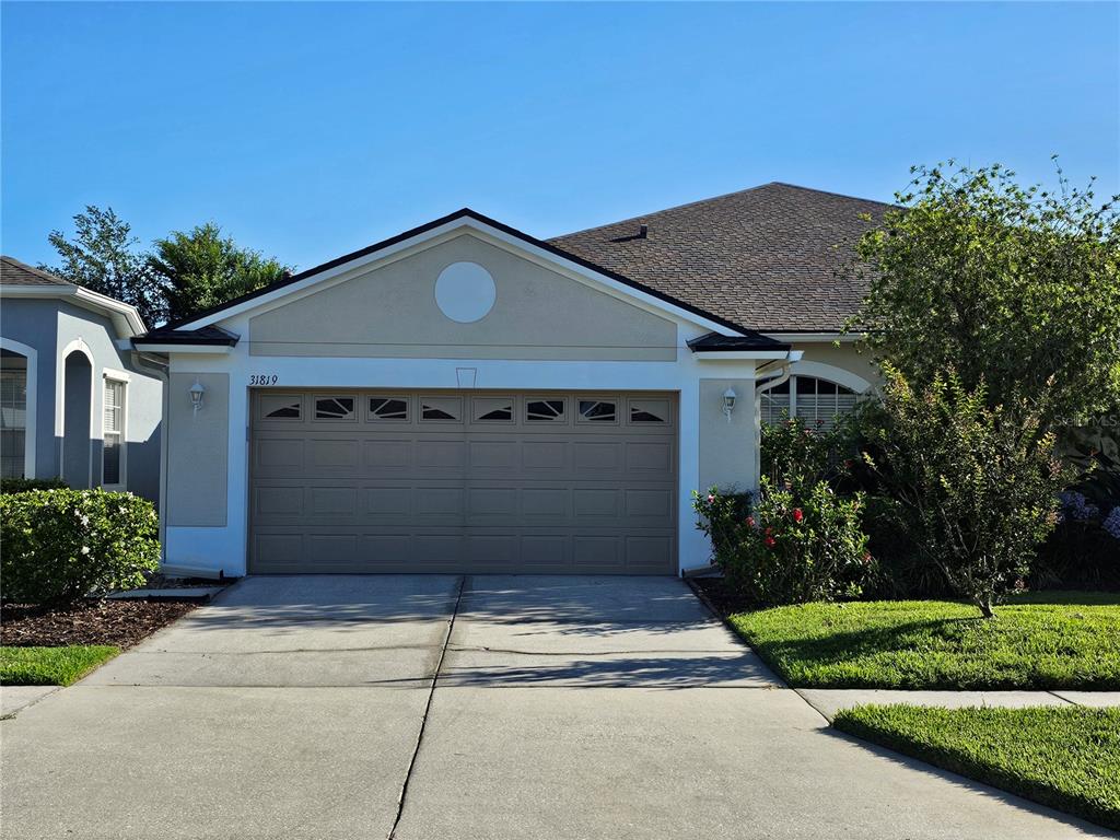 a front view of a house with a yard and garage