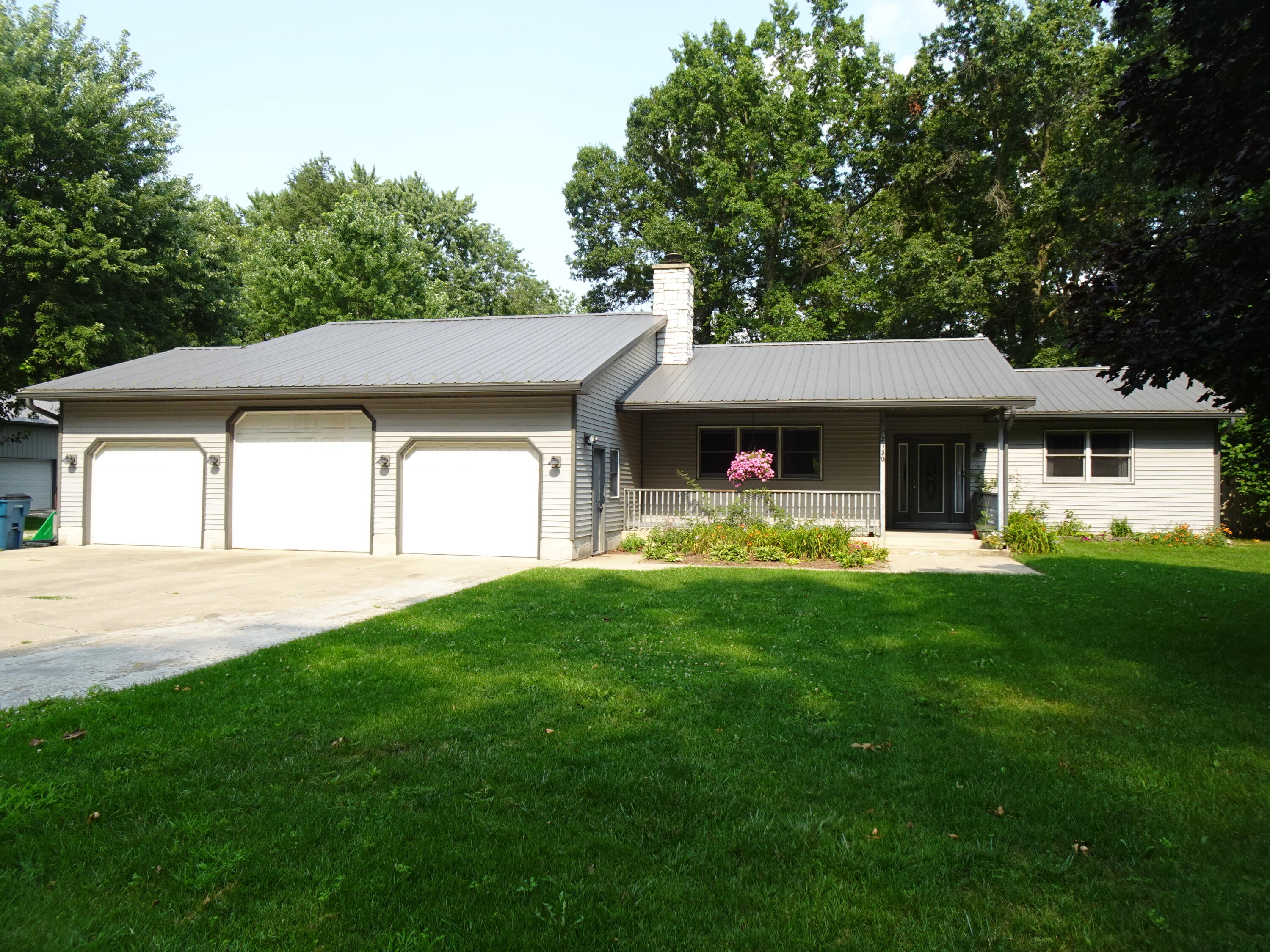 a front view of a house with a garden and porch