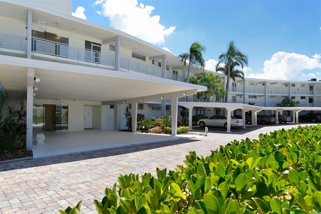 a front view of a building with garden and patio