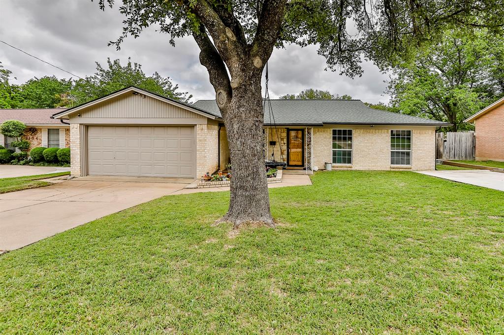 a front view of house with yard and green space