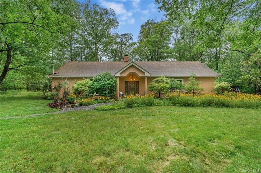 Ranch-style home featuring a front yard