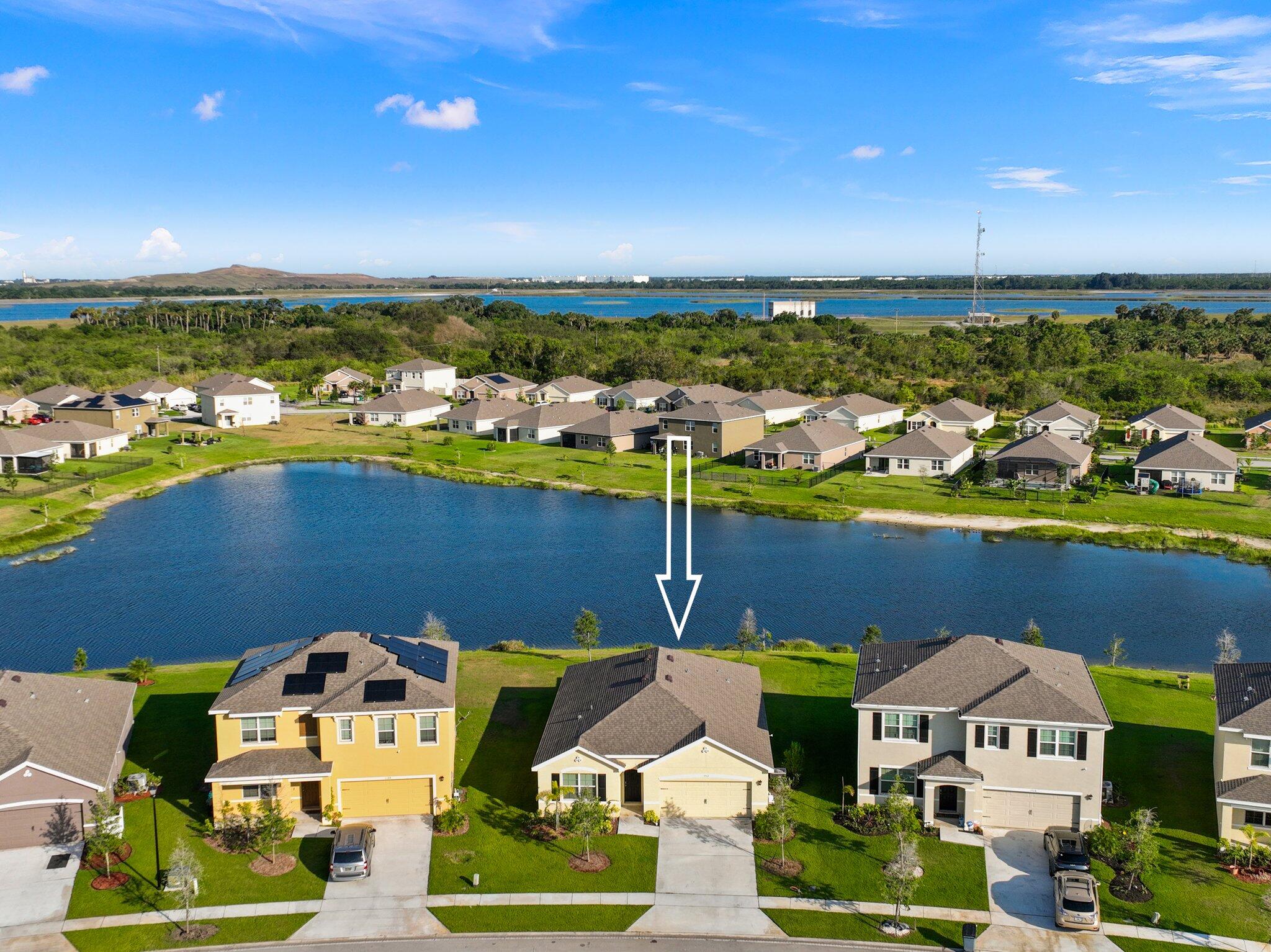 an aerial view of a house with a lake view