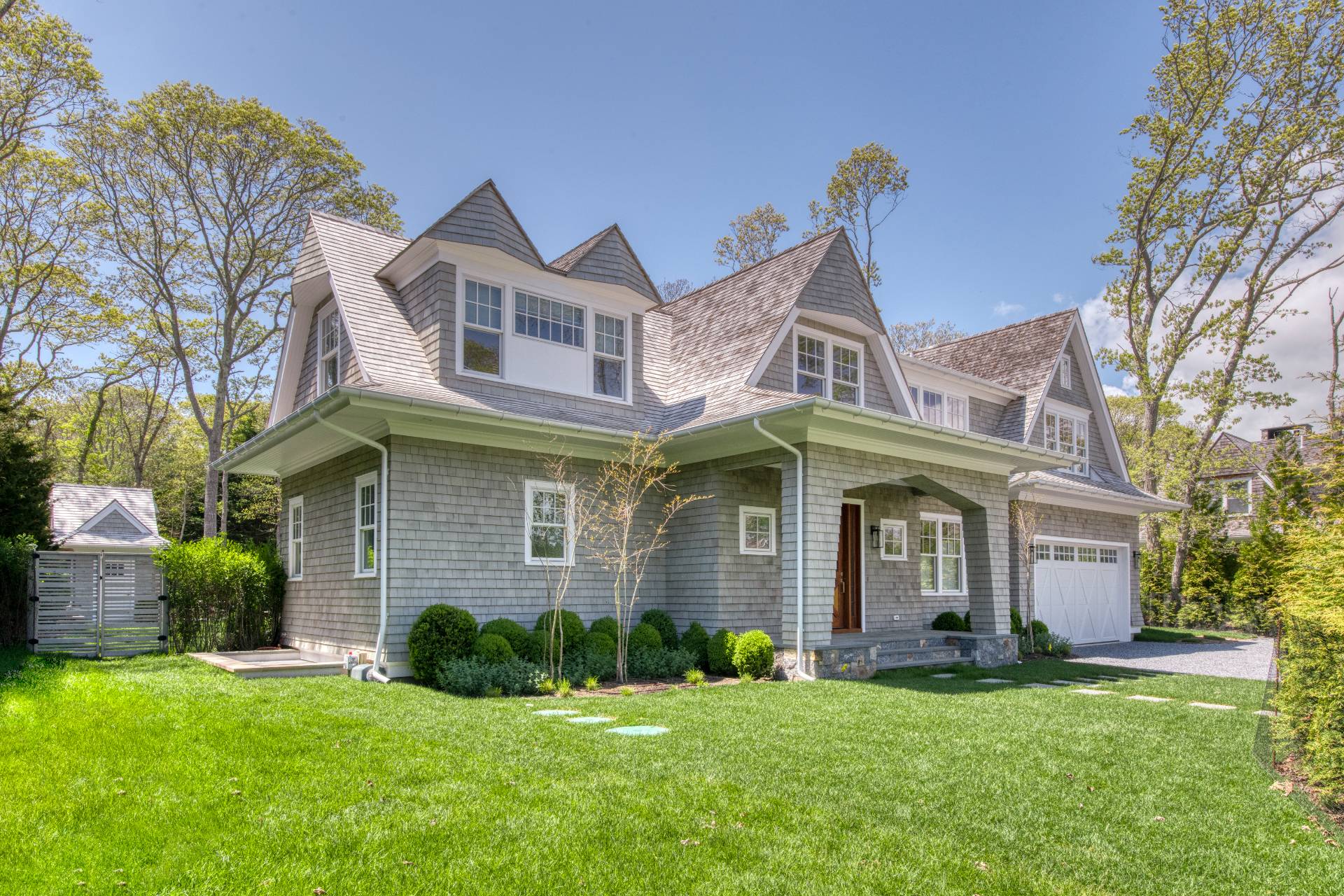 a front view of a house with a garden