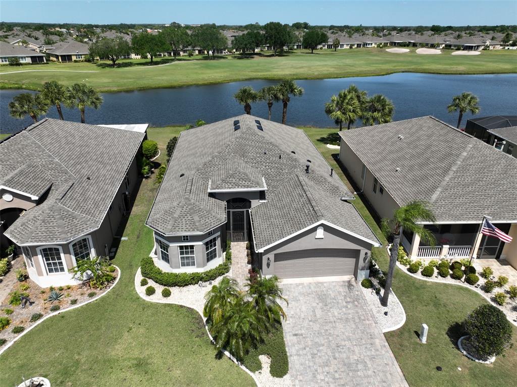 an aerial view of a house with outdoor space and lake view