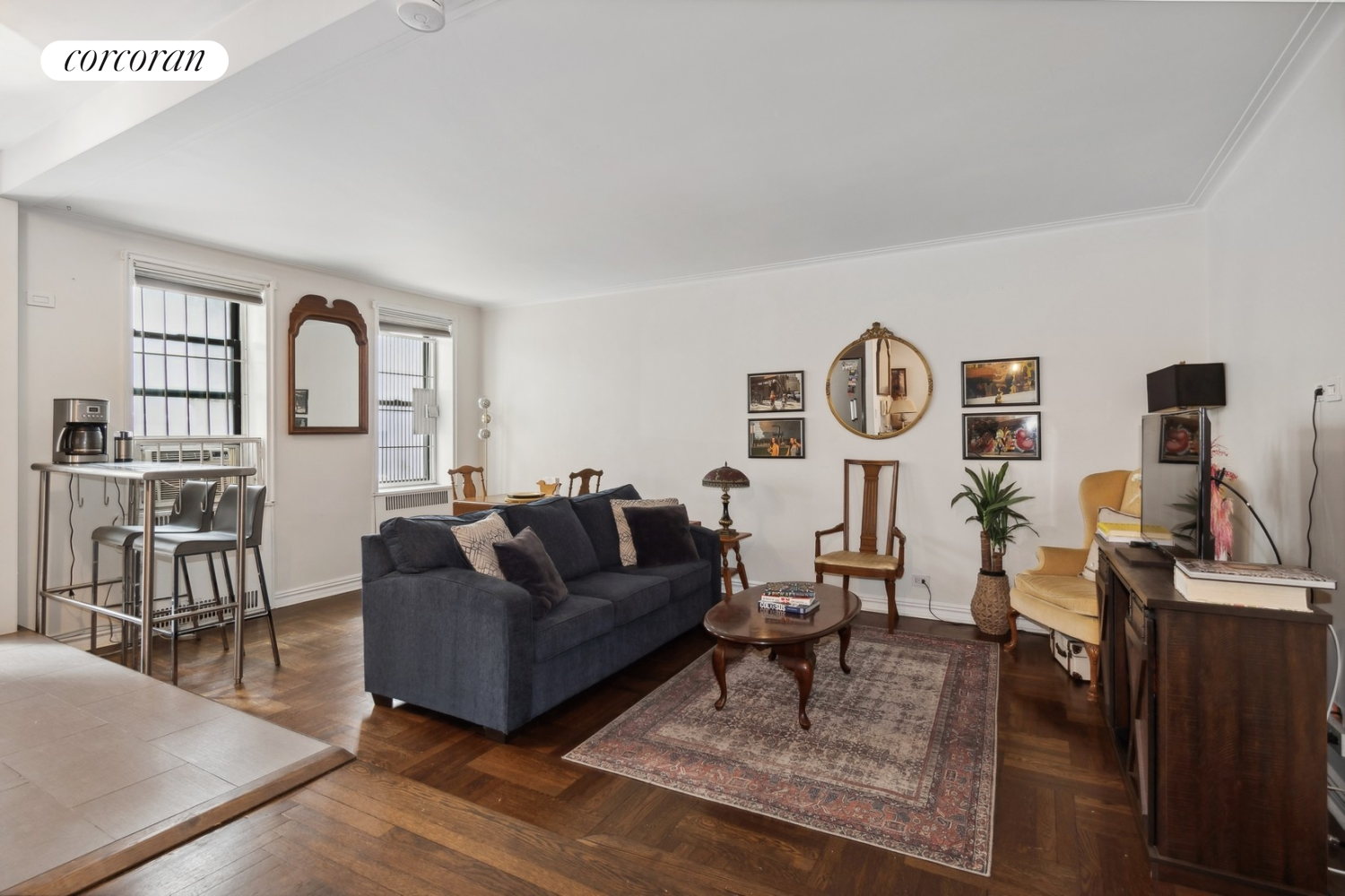 a living room with furniture and wooden floor