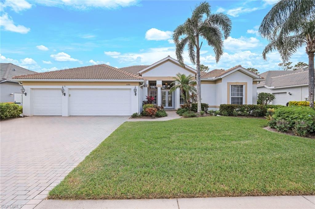 View of front of home featuring a garage and a front lawn