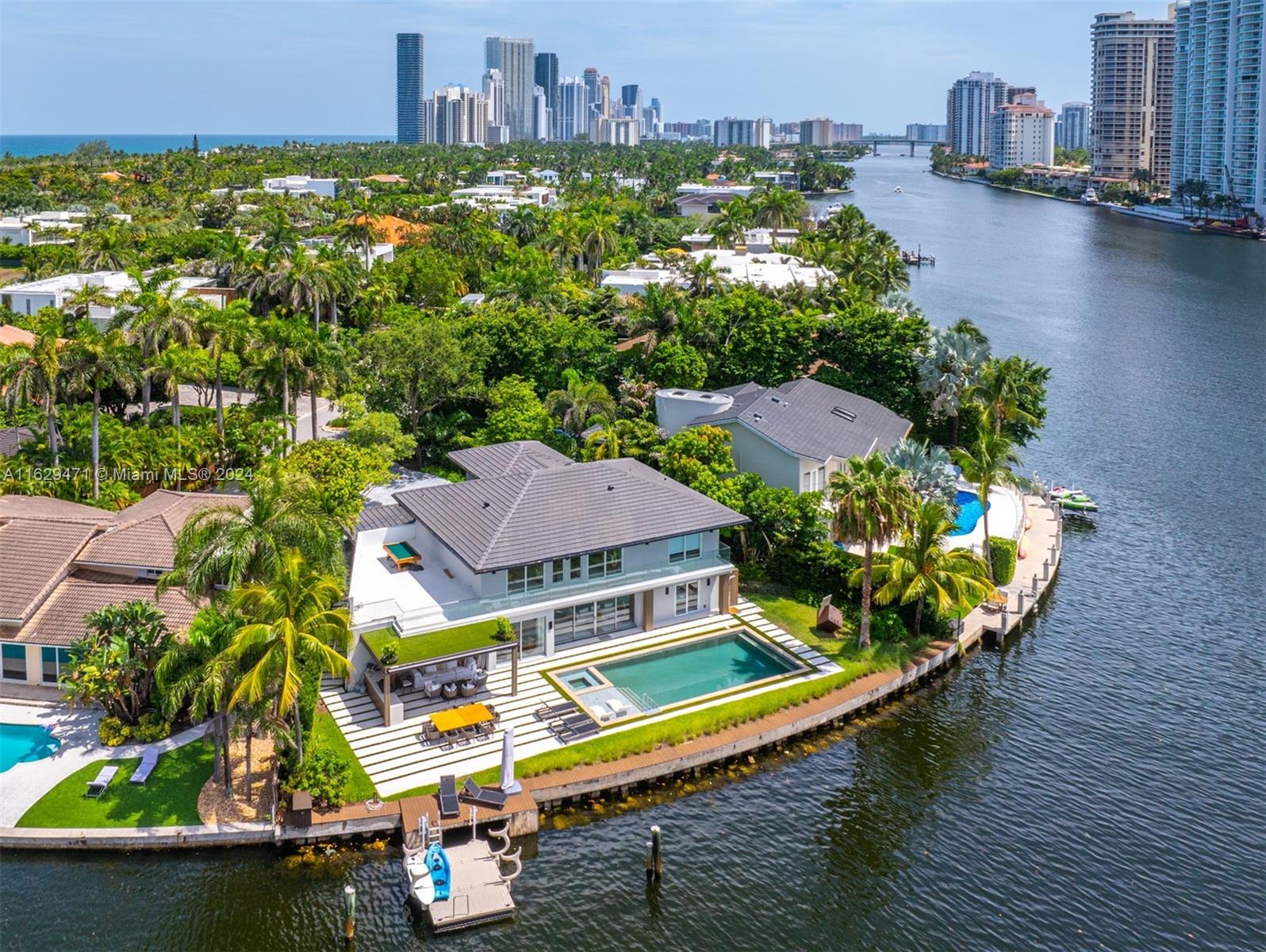 an aerial view of a house with a swimming pool patio and outdoor seating