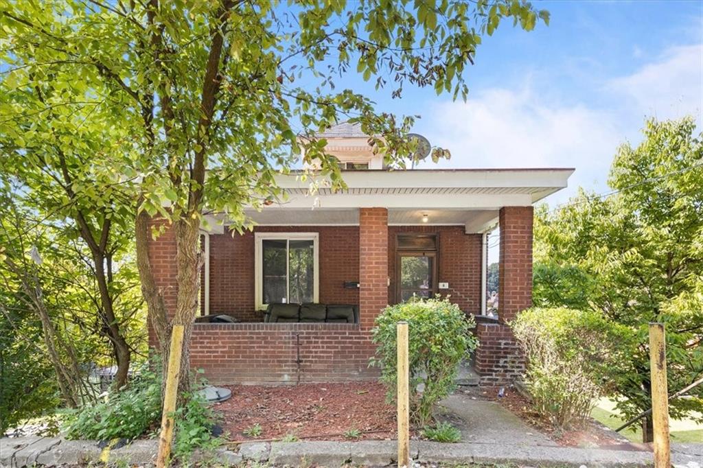 front view of a house with potted plants