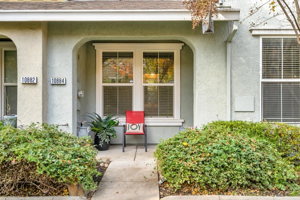 a view of a house with potted plants