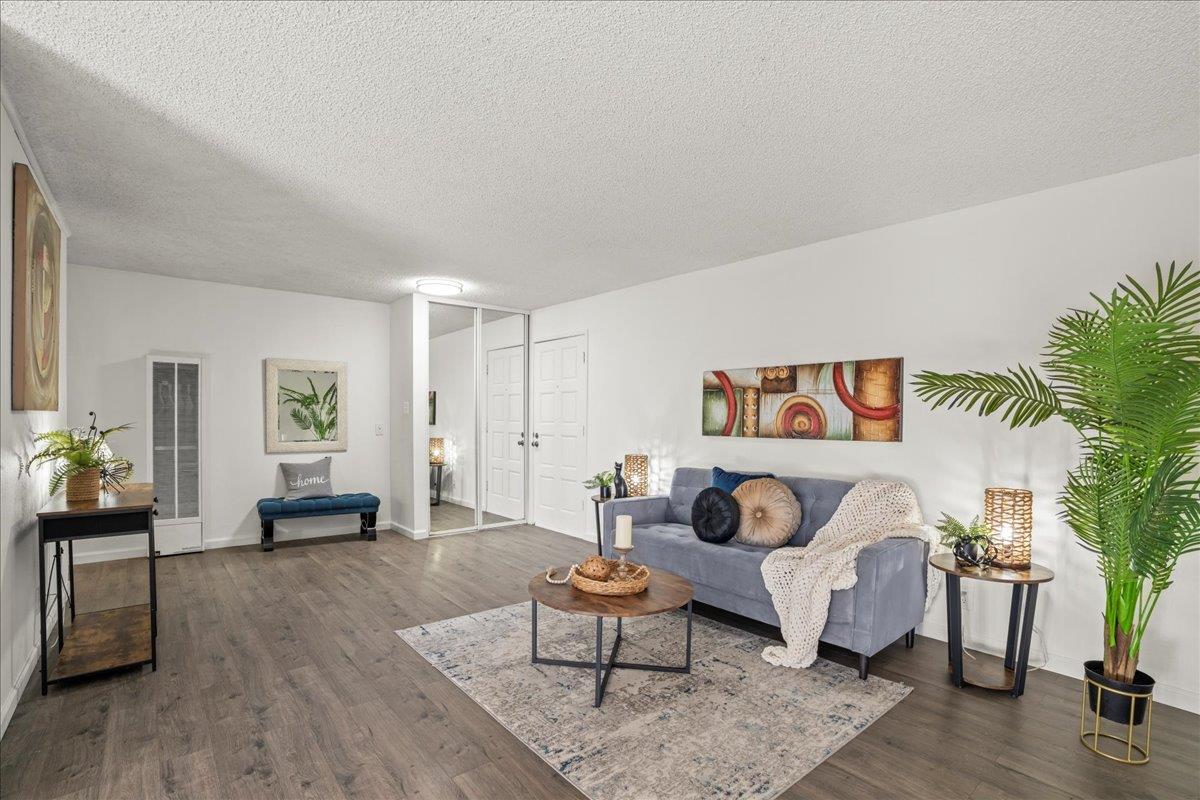 a living room with furniture and wooden floor