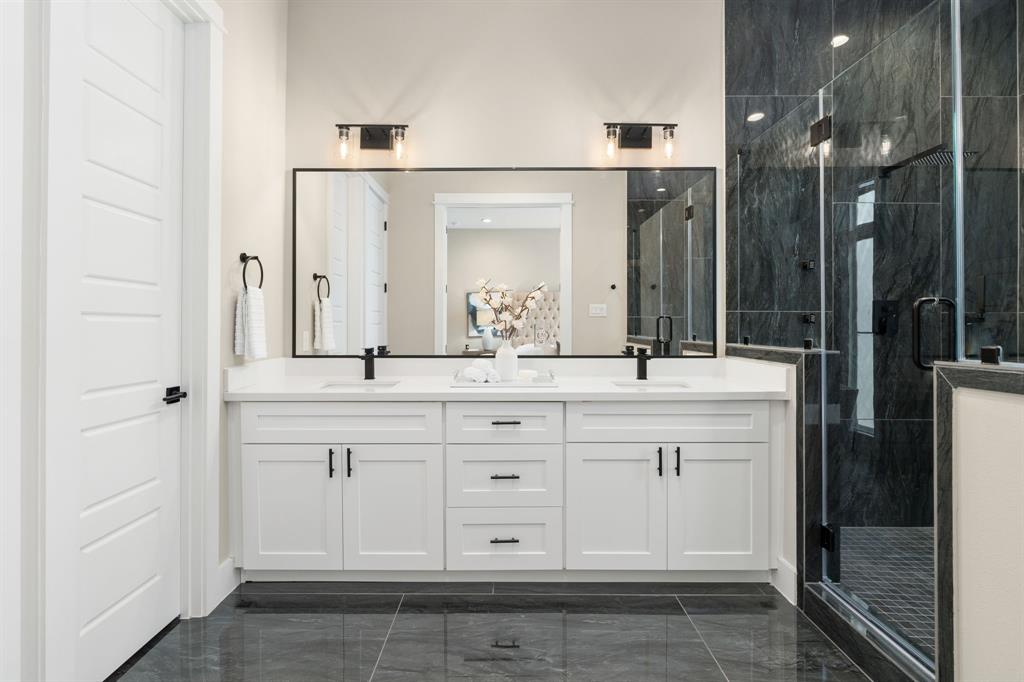 a bathroom with a double vanity sink and a mirror