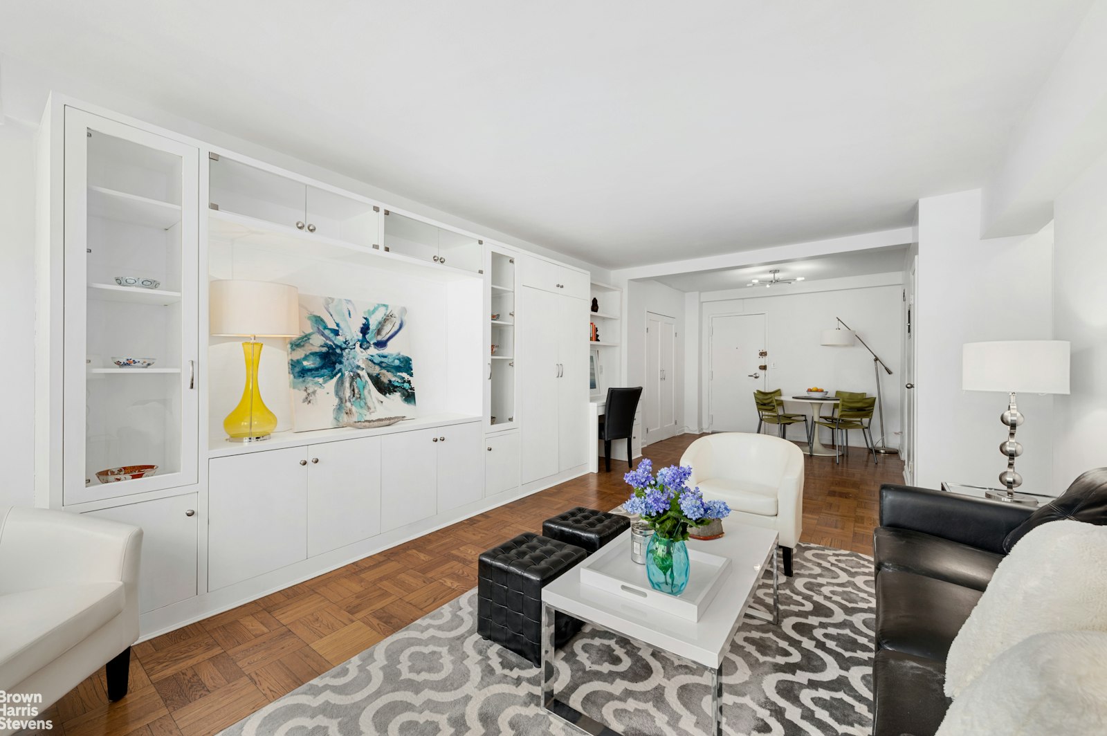 a living room with furniture and painting on the wall