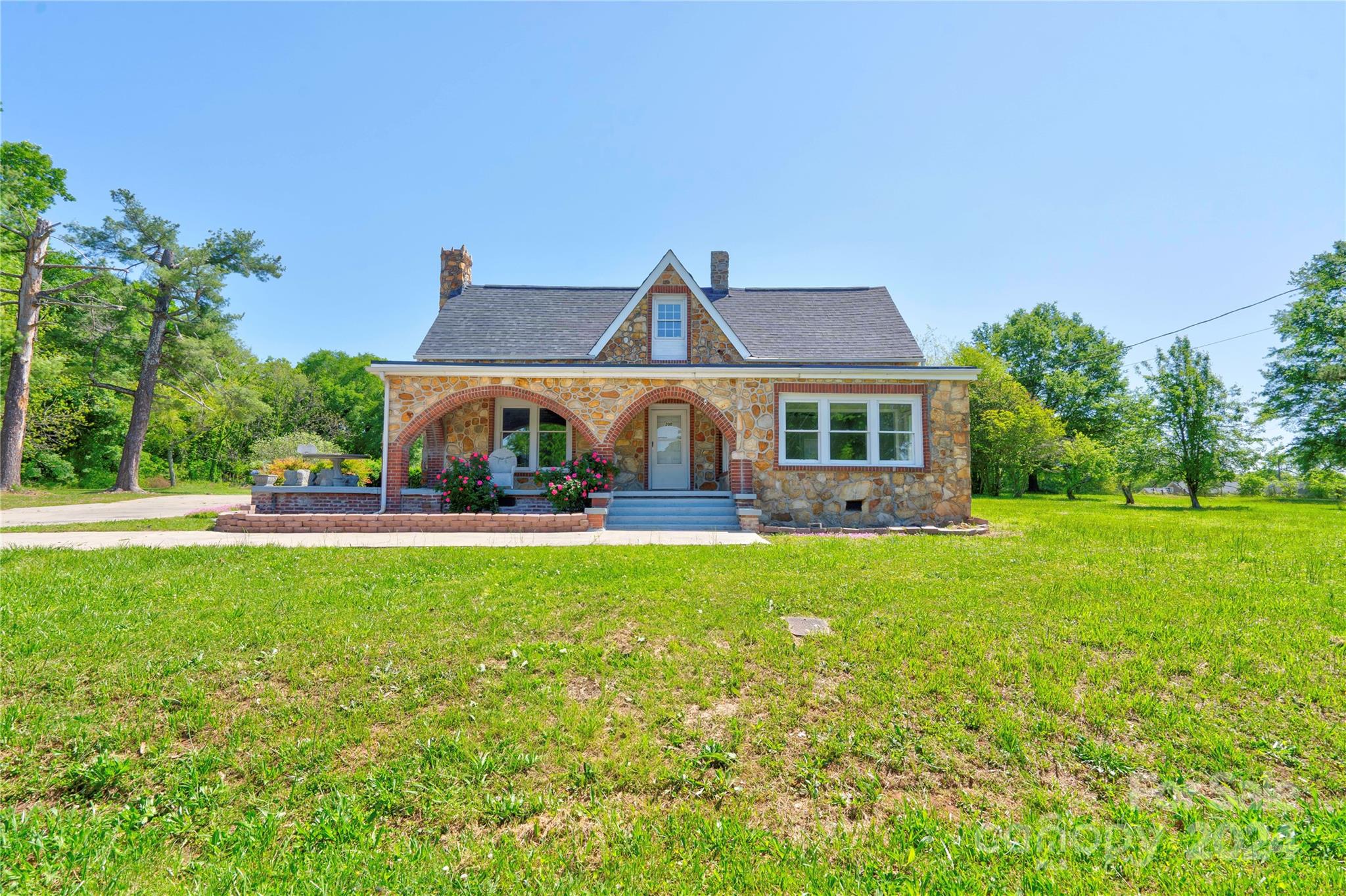 a front view of house with yard and green space