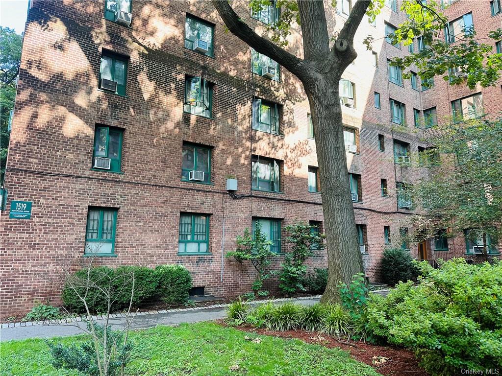 a view of a brick building next to a yard