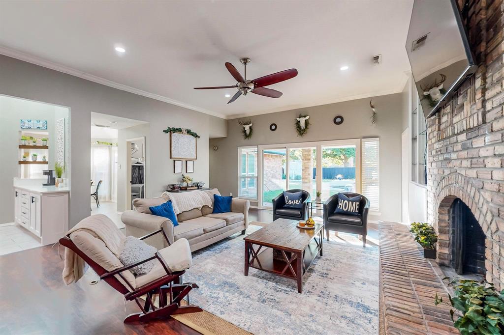 a living room with furniture a fireplace and a chandelier