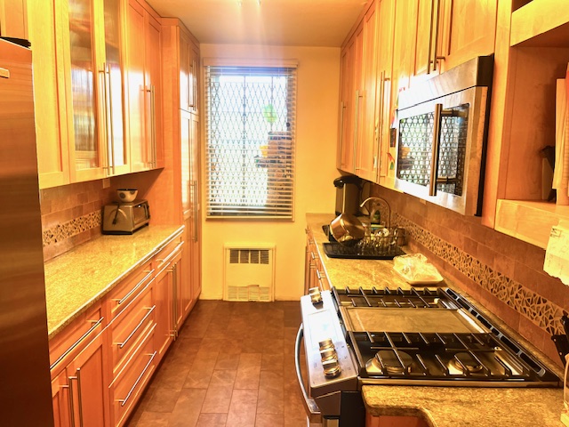 a view of a kitchen with a large window