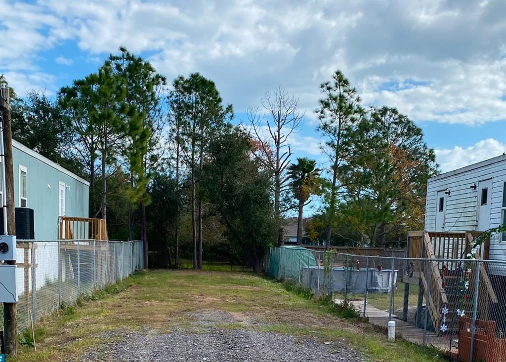 a view of a backyard with a tree