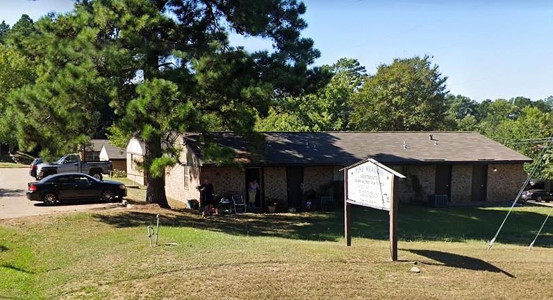 a view of a house with backyard porch and sitting area