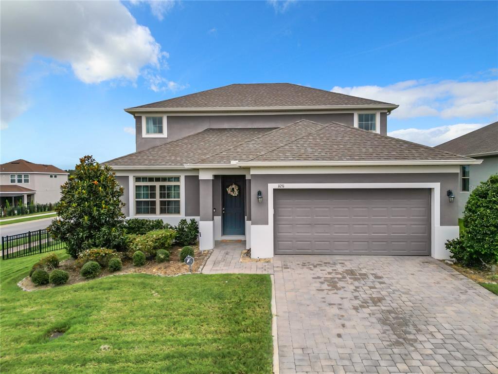 a front view of a house with a yard and garage