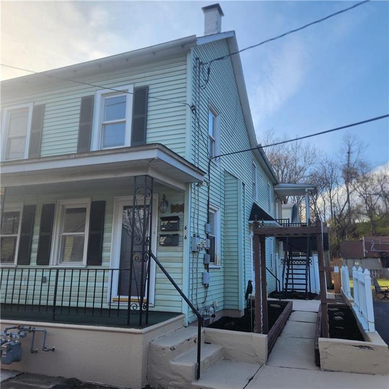 a view of a house with iron stairs