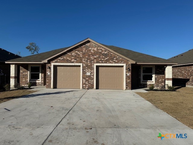 a front view of a house with yard and parking space