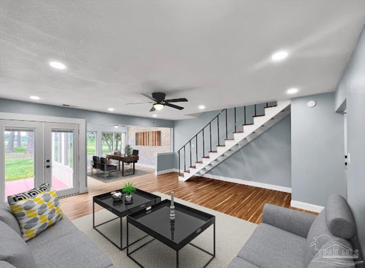 a living room with furniture and wooden floor