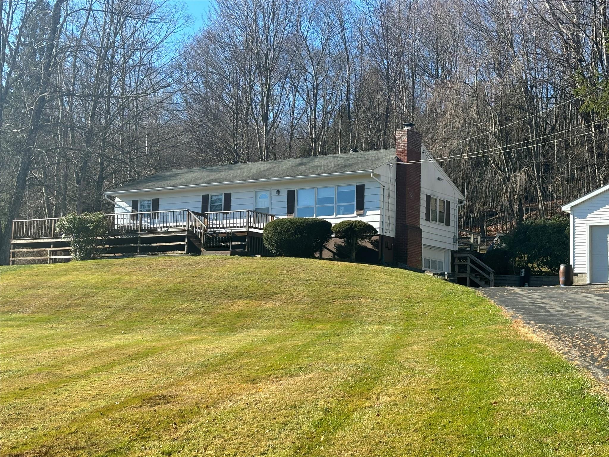 a front view of a house with a yard and trees