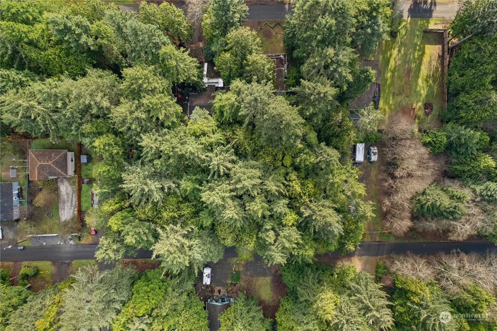 an aerial view of residential house with outdoor space and trees around