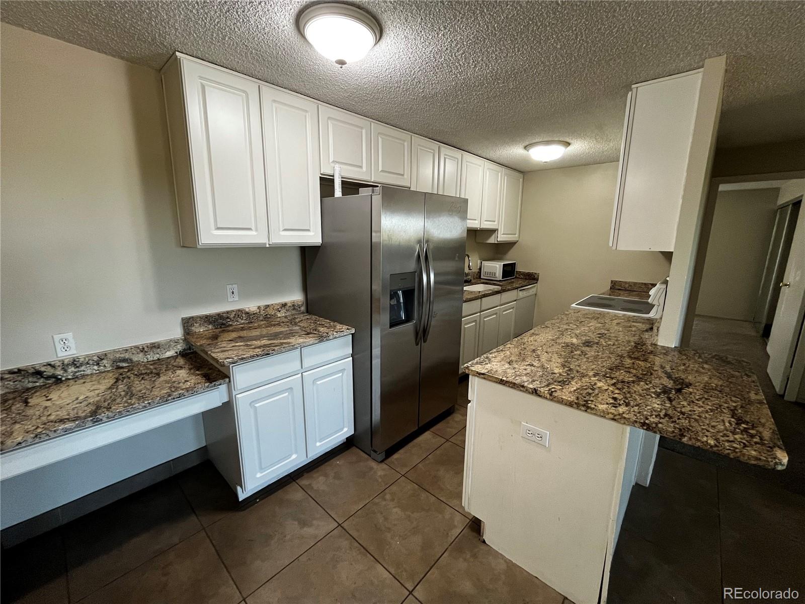 a kitchen with a sink stove and refrigerator