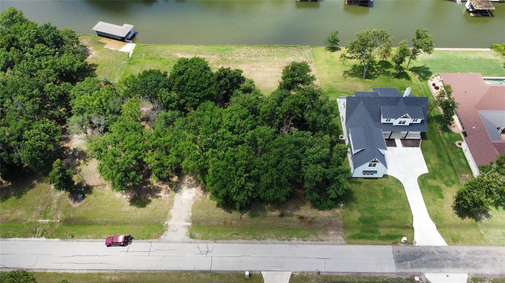 an aerial view of a house with a yard basket ball court and outdoor seating