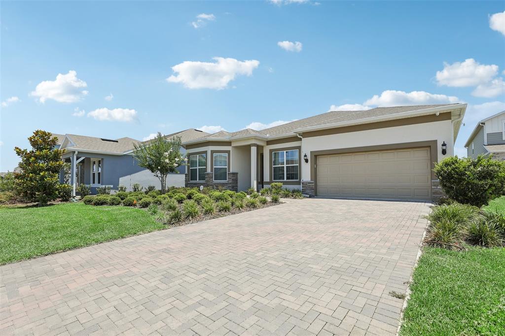 a front view of a house with a yard and a garage