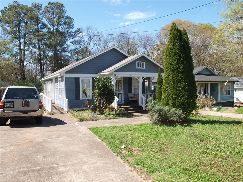 a view of a house with backyard sitting area and porch